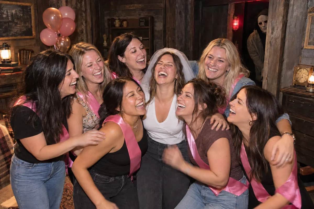 A bachelorette group laughing together inside the escape room